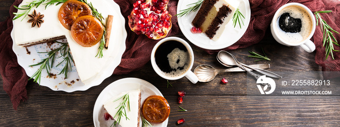 Pieces of delicious chocolate cake with orange jam covered with cheese cream. Christmas dinner concept. Selective focus. Top view. Copy space.