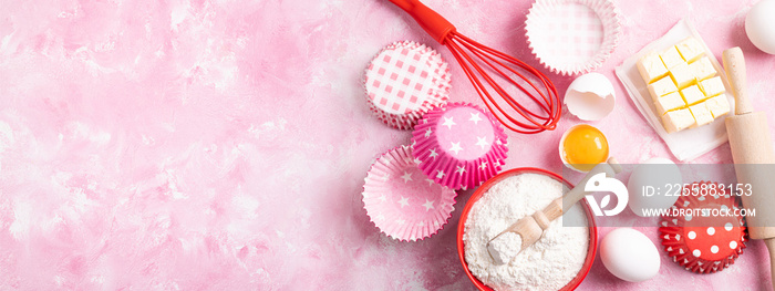 Baking background. Food ingredients for baking flour, eggs, sugar on pink background flat lay. Baking or cooking cakes or muffins. Long format with copy space. Top view