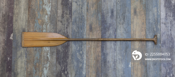 wooden sports paddle on an old wooden background