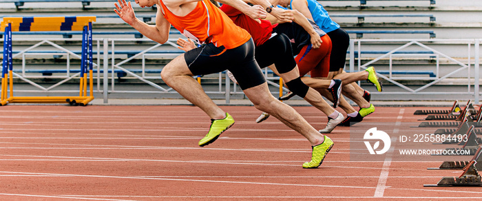 start sprint men runners run 100 meters at stadium