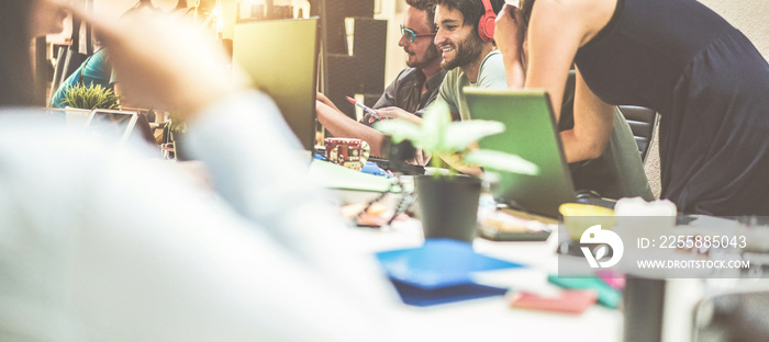 Young teamwork talking during startup - Happy people planning a new project in creative co-working office - Technology, entrepreneur, marketing and concept - Soft focus on right man face