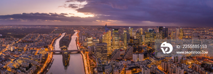 Panoramic aerial drone shot of la seine river besides la defense skyscraper complex during sunset hour