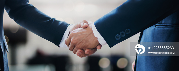 successful contract negotiate and handshake concept, two businessman shake hand with partner to celebration partnership, teamwork, business deal in room meeting after success communication, agreement