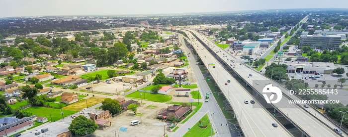 Panorama aerial view highway 90 (U.S. Route 90, US-90) and elevated Westbank expressway in suburban New Orleans, Louisiana. Massive intersection, stack interchange, road junction overpass with traffic