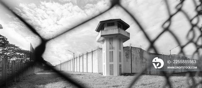 Prison with iron fences.Prison or jail is a building where people are forced to live if their freedom has been taken away.Prison is the building use for punishment prisoner.