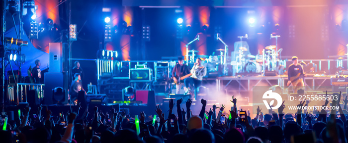 crowd with raised hands at concert festival