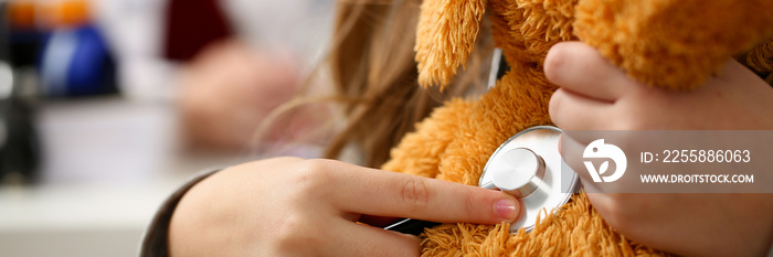 Female hand of little girl hold stethoscope listen heart bit concept closeup