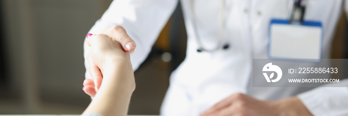 Doctor woman greet patient and shake hand, medical worker in uniform