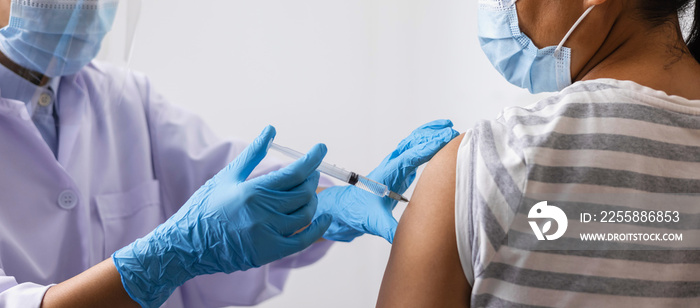 Female doctor giving shot vaccine patient shoulder. Vaccination prevention virus covid19 pandemic.