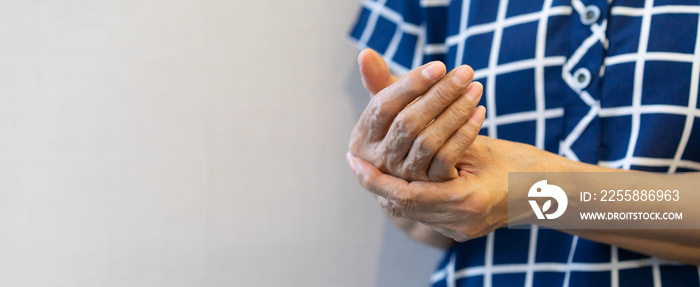 close up senior woman massage on hand to relief pain from hard working for treatment about carpal tunnel syndrome and chronic illness health care concept