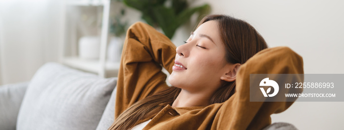 Young woman enjoying mind free moment relax and calm on the sofa at home.