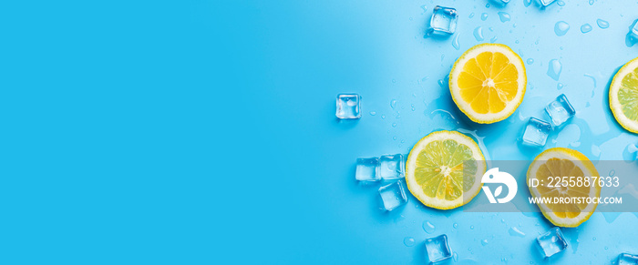 juicy fresh lemon slices and ice on a blue background. Top view, flat lay. Banner