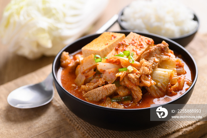 Kimchi soup with tofu and pork in a bowl eating with cooked rice, Korean food