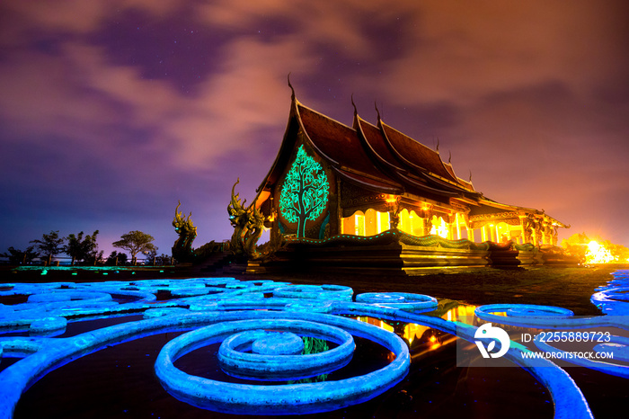 Amazing Temple Sirindhorn Wararam Phuproud in Ubon Ratchathani Province at twilight time,Thailand.Thai temple with grain and select white balance.Night sky effect for Long exposure photo taken.