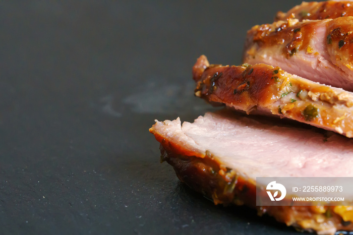 Sliced duck fillet on granite plate. Close-up view.