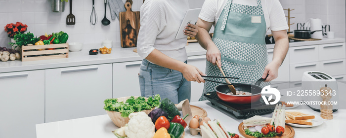 Young couple cooking together