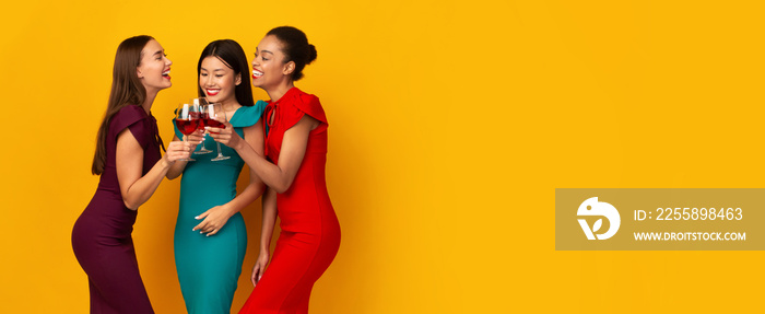 Three Girls Holding Red Wine Glasses Talking Over Yellow Background