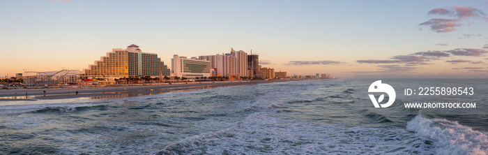 Panoramic view of a beautiful sandy beach during a vibrant sunrise. Taken in Daytona Beach, Florida, United States.