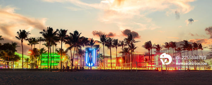 Miami Beach Ocean Drive panorama with hotels and restaurants at sunset. City skyline with palm trees at night. Art deco nightlife on South beach