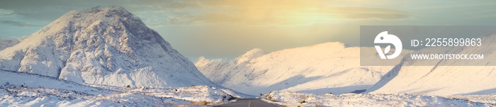 Buachaille Etive Mor mountain and empty road covered in snow during winter