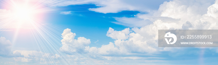 Bright sun in the blue sky with clouds panoramic view