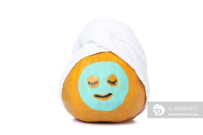 Pumpkin with facial mask and towel isolated on white background