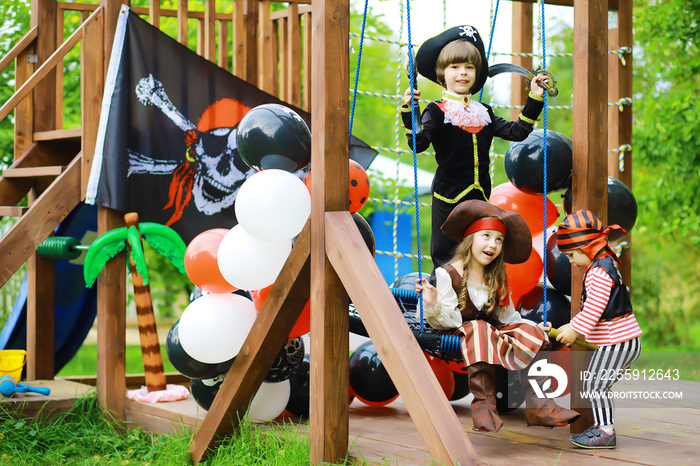 Childrens party in a pirate style. Children in pirate costumes are playing on Halloween.