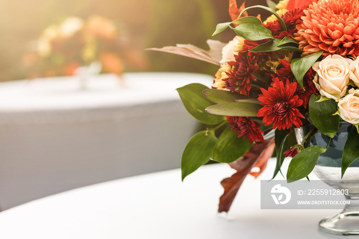 autumnal flowers and berries in a vase