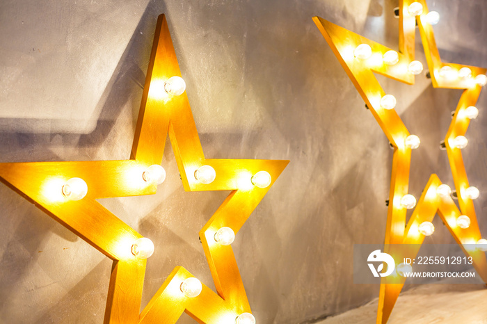 Decorative star with lamps on a background of wall. Modern grungy interior