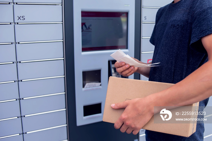 Client using automated self service post terminal machine or locker to deposit a parcel for storage