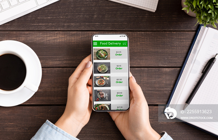 Hand touching phone screen for choosing food