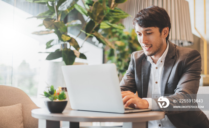 Asian businessman using laptop while working in office