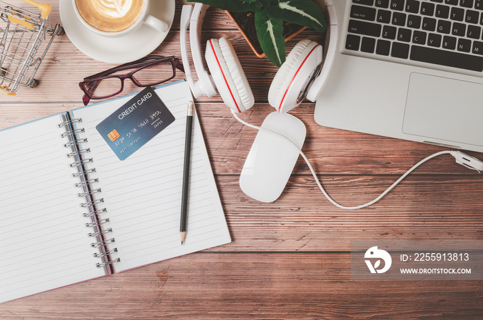 credit card on blank note book with pencil on wooden office desk.