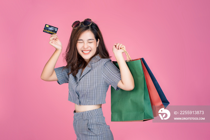 Asian woman online shopping bag promotion sales using credit card purchasing products online transac