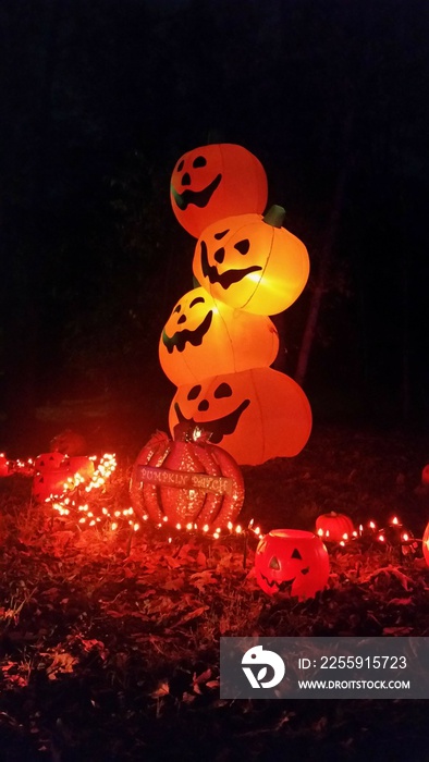 halloween pumpkins stacked in the night