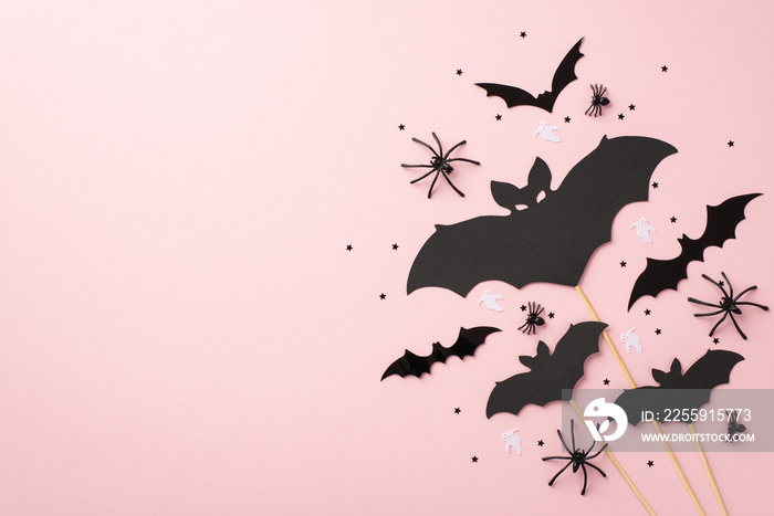 Halloween concept. Top view photo of bat silhouettes spiders ghost silhouettes and black confetti on