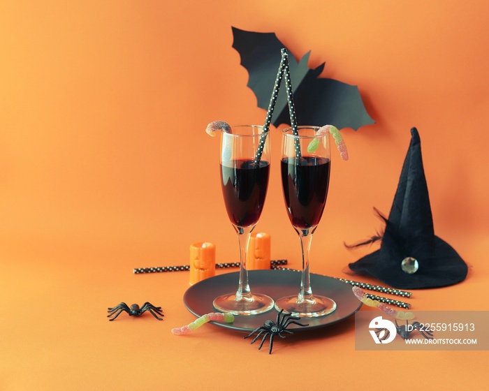 Happy Halloween, red wine in glasses, mystical decor on a bright background, concept of a festive tr