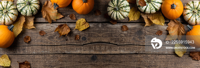 Autumn composition from pumpkins and autumn leaves on wooden background. Concept of Thanksgiving day