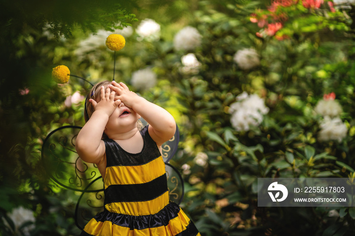 OMG . Baby girl in costume of bee closing eyes with hands . Funny expression. Copy space