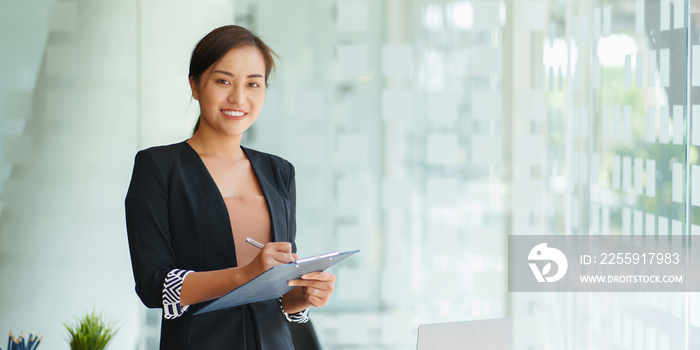 A portrait of Asian happy Businesswoman smiling and working at office.