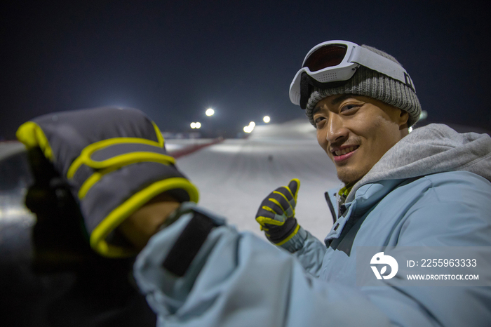 夜晚青年男人站在滑雪场内