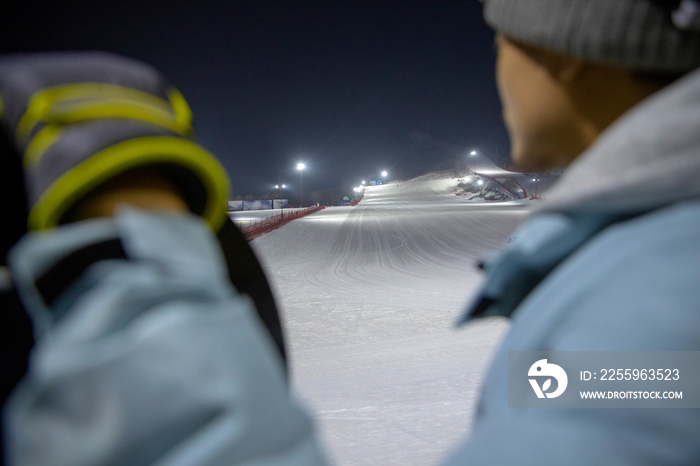 夜晚青年男人站在滑雪场内