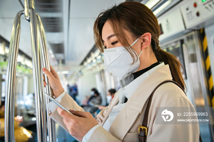 青年女人在地铁上看手机