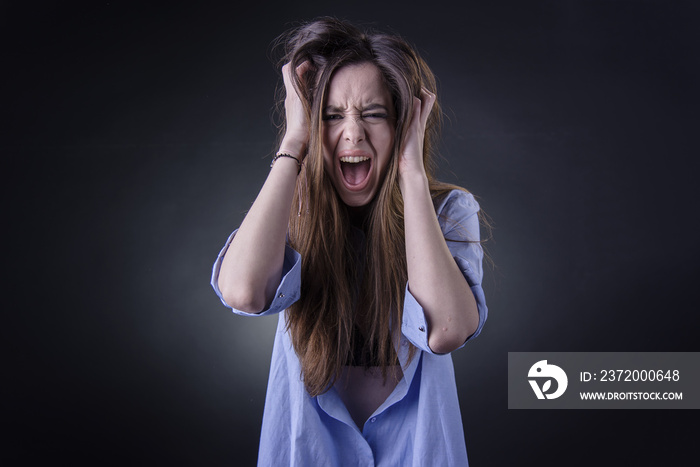 Maniac woman screaming, angry and frustrated, white background, very long hair