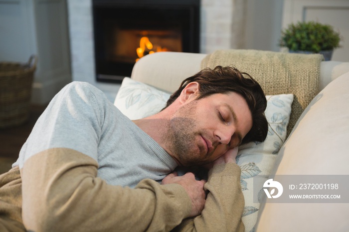 Man sleeping on sofa in living room