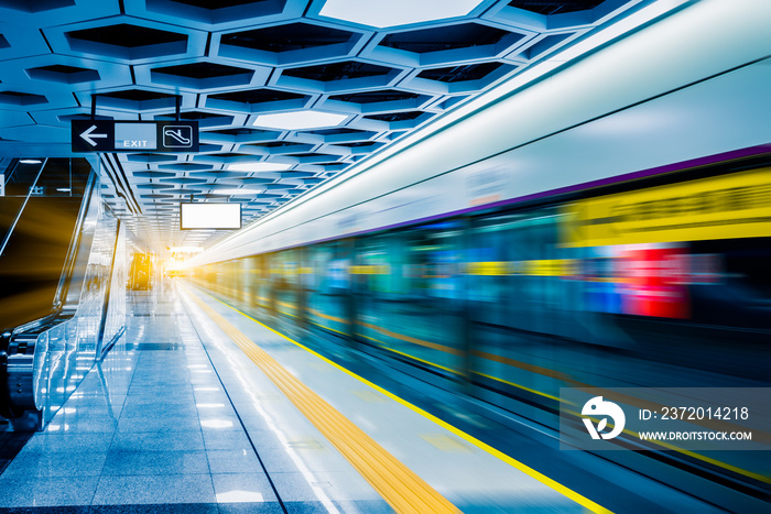 Blurred view of train leaving platform in city of China.