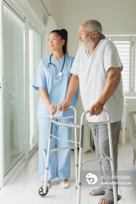 Healthcare worker with man using walking support
