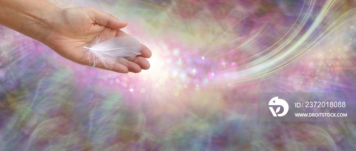 Receiving Angelic help - female open palm hand with a single white feather against a flowing etherea