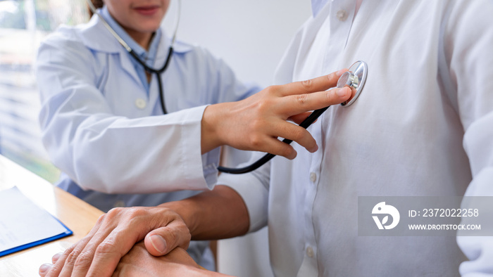 Medical concept a female doctor examining the patient by using stethoscope on the patient’s breast