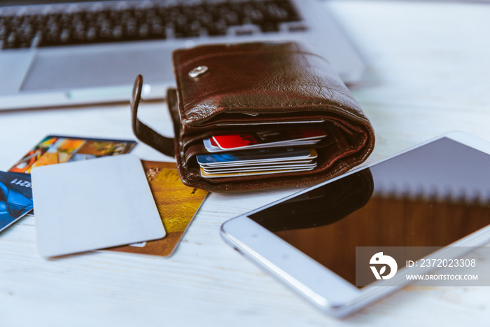 laptop wallet glasses phone on table